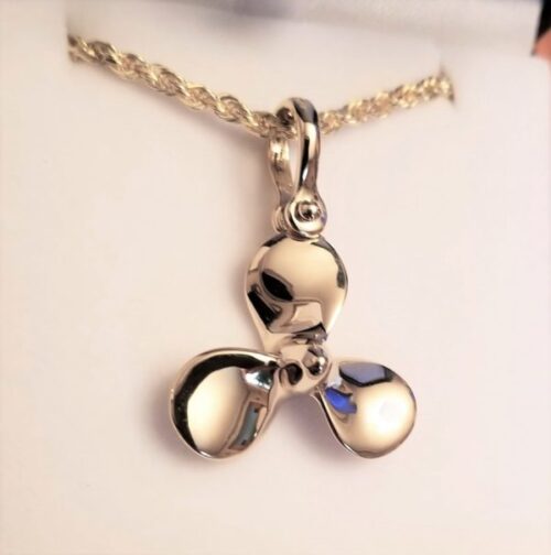 A shiny silver pendant shaped like a stylized flower or clover on a delicate chain.