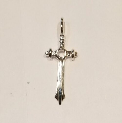 Elegant silver cross pendant with intricate detailing.