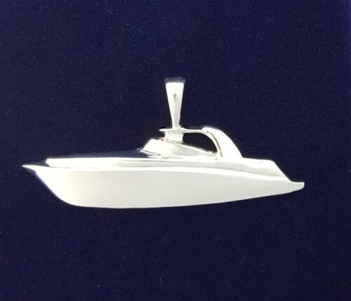 Silver pendant shaped like a sleek yacht on a dark background.