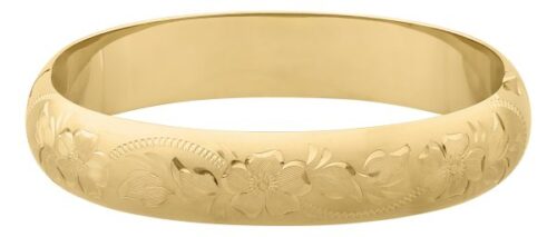 Gold bracelet with floral engravings on its surface.