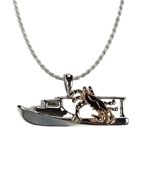 Silver pendant featuring a crab and a boat.